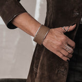 Close-up of a person wearing a brown suede coat with a blurred background
