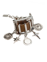 Chunky silver cuff bracelet featuring brown snake-print leather and five dangling silver charms, adjustable fit.