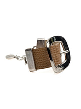 Textured beige leather cuff bracelet featuring a prominent silver buckle, adjustable chain, and polished hardware.
