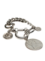 Silver-plated shackle bracelet with chunky chain and large vintage coin pendants, featuring an industrial U-lock clasp.