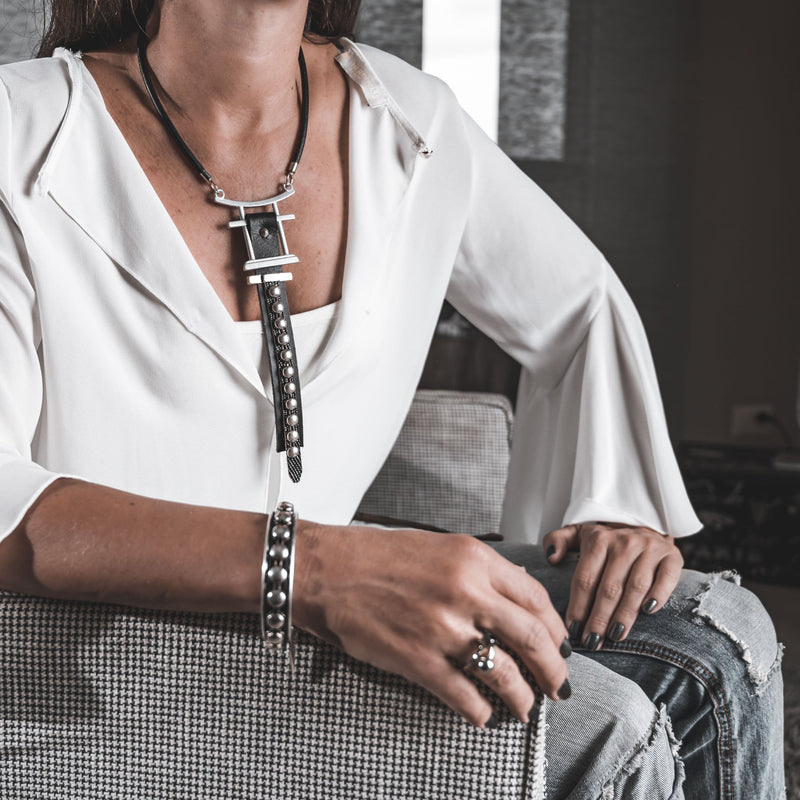 Rock style chocker necklace made of a sturdy metal design and black leather with studs