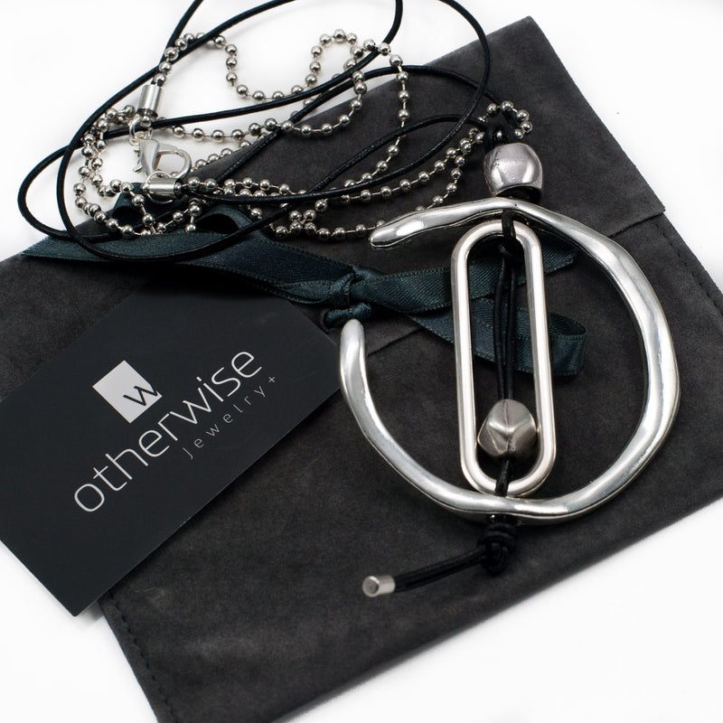 Necklace with unique asymmetrical metal design, created in the Uno de 50 style