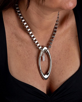 Chunky stainless steel box chain necklace featuring an oversized silver-plated carabiner clasp worn as a choker.