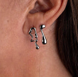 Asymmetric lava drop stud earrings in silver with mismatched geometric dripping design