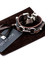 Leather Statement Bracelet featuring silver-plated metal accents, dark brown and black leather, and stud details.