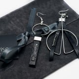 Funky earrings made of black leather with strass and silver-plated elements, different earring on each ear worn together or individually