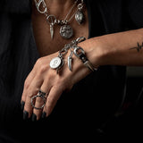 Silver charm bracelet, leather and metal bracelet with coins