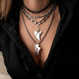 Layered stainless steel necklaces with oval link choker, labradorite gemstone choker, tooth pendant and feather pendant