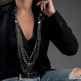 Leather chain layered necklace with multiple strands, gunmetal loop, large buckle, and silver-plated chains