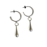 Chunky sterling silver hoop earrings featuring a unique teardrop charm, handcrafted with a polished finish.