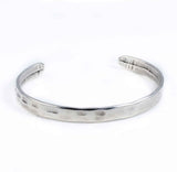 Silver malleable bangle bracelet with a hammered texture, featuring a minimalist design suitable for stacking.