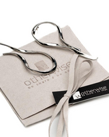 Silver scissors on a branded box with 'otherwise' branding.