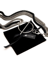 Layered triple chain necklace featuring stainless steel snake chains and a black aluminum chain with a large T-clasp.