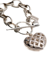 Textured heart charm bracelet in antique-plated silver, with a woven heart pendant and a toggle clasp for secure wear.