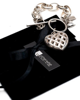 Textured heart charm bracelet featuring a detailed heart pendant on an antique-plated silver chain.