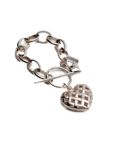 Textured heart charm bracelet featuring an antique-plated silver chain and intricately detailed heart pendant.