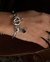 Chic stainless steel bracelet with silver oval link chain, featuring a Swarovski crystal charm and unique T-bar closure.