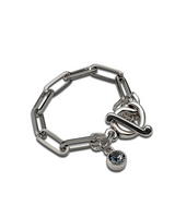 Chic stainless steel bracelet featuring a silver oval link chain and a “Silver Night” Swarovski crystal charm.