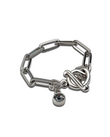 Chic stainless steel bracelet featuring a silver oval link chain and a Swarovski crystal charm with a T-bar closure.