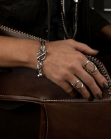 Chic stainless steel bracelet featuring a Swarovski crystal charm and unique T-bar closure, worn on a model's wrist.