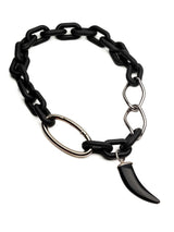 Matte black acrylic chain necklace with a large silver carabiner clasp and a black agate tooth pendant.