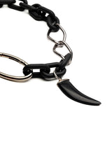 Chunky black acrylic chain necklace featuring a black agate tooth pendant and silver carabiner clasp, edgy and industrial style.