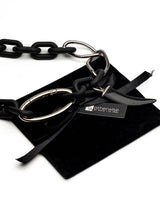 Matte black acrylic and silver chain necklace featuring a genuine black agate tooth pendant and large carabiner clasp.
