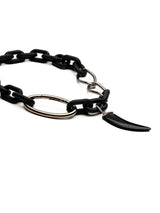 Matte black acrylic chain necklace featuring a chunky design, a silver carabiner clasp, and a black agate tooth pendant.