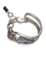 Silver ring with a blue stone on a white background