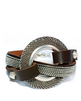 Bold textured disc bracelet featuring brown leather and strass, designed for a rock-style look with an adjustable fit.