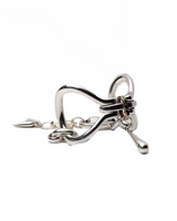 Chunky silver metal cuff bracelet featuring sculptural, organic link shapes and an adjustable extension chain for fit.