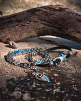 Silver bracelet with charms on a textured surface