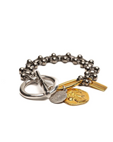Bracelet with various charms on a white background