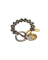 Bracelet with various charms on a white background