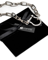 Silver shackle jewelry set featuring a chunky chain bracelet and choker, displayed with a black suede pouch.
