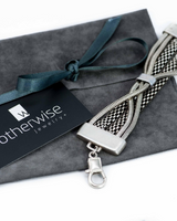Bold chunky snake chain bracelet in antique silver with multiple intertwined chains, presented in a suede pouch.