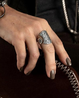 Four boho rings in sterling silver plated zamak are worn on a hand, showcasing an ethnic design and floral engraving.