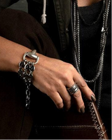 Boho Rings Set worn on fingers, showcasing detailed designs including a Hamsa Hand and ethnic calendar, paired with a leather bracelet.