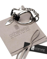 Metal and leather rock-style bracelet featuring an irregular silver-plated design with a black leather strap.