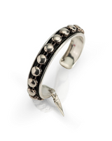 Silver ring with bead detailing and a pointed design on a white background