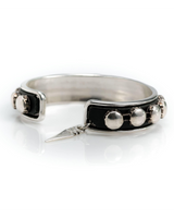 Silver ring with black band and decorative elements on a white background