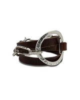 Wrap leather and metal statement bracelet featuring brown leather strands, sculpted silver-plated accents, and adjustable fit.