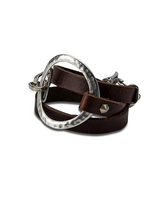 Brown and black leather wrap bracelet featuring a sculpted silver-plated metal accent and adjustable closure.