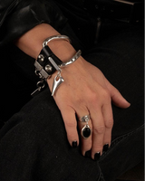 Handcuffs on a wrist with a black background