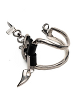 Silver keychain with a black cat design on a white background