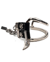 Metallic keychain with a black square design on a white background