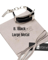 Black and silver metal bracelet on a branded box with 'Otherwise' branding.