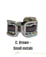 Pair of silver buckles with brown leather straps on a white background