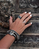 Adjustable silver-plated copper irregular funky bar ring showcased on a hand with manicured white nails, resting on an ornate door.
