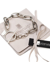 Bold chunky chain anklet featuring a silver link design and a stylish T-clasp, presented on a suede pouch.